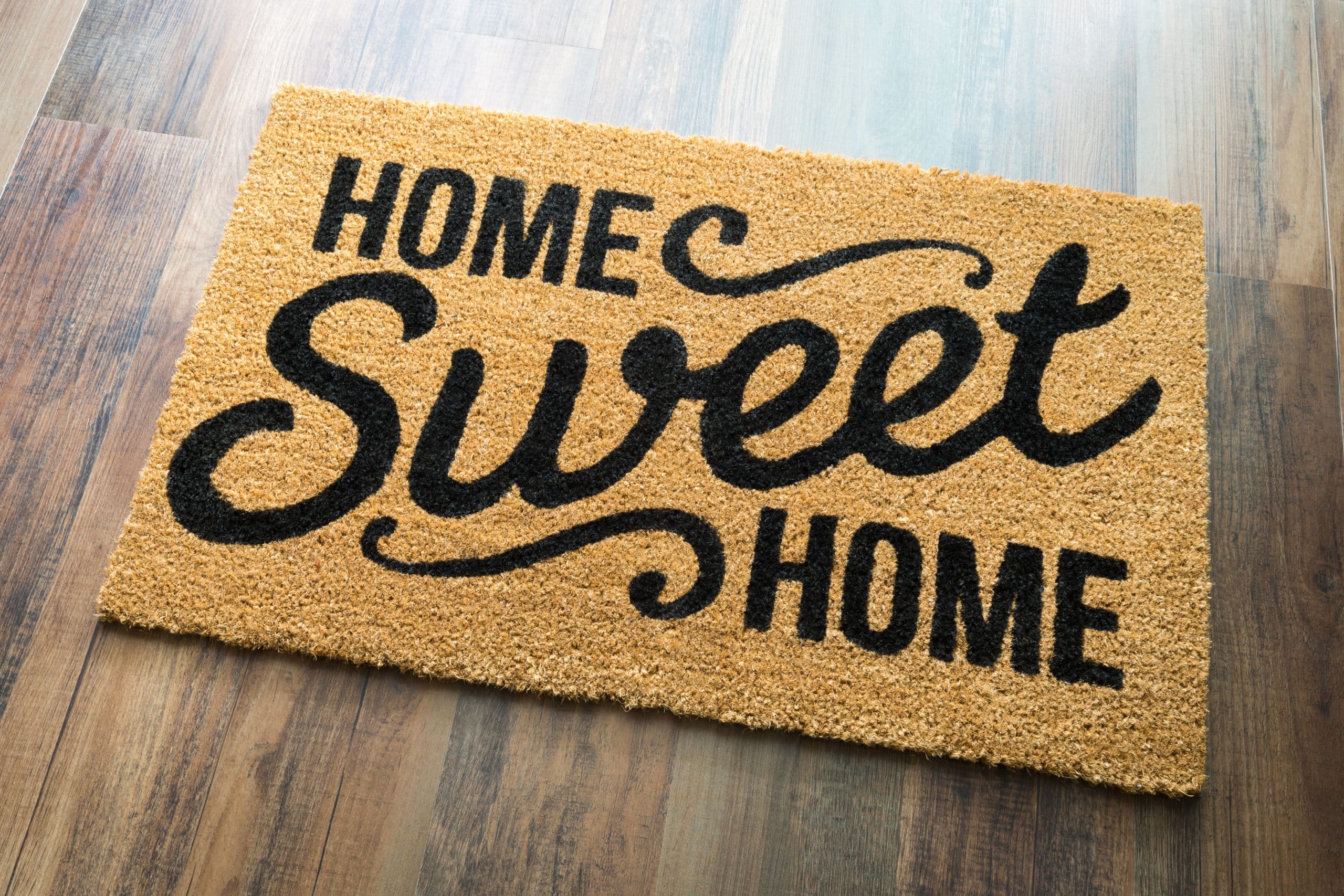 Home Sweet Home Welcome Mat On Wood Floor.